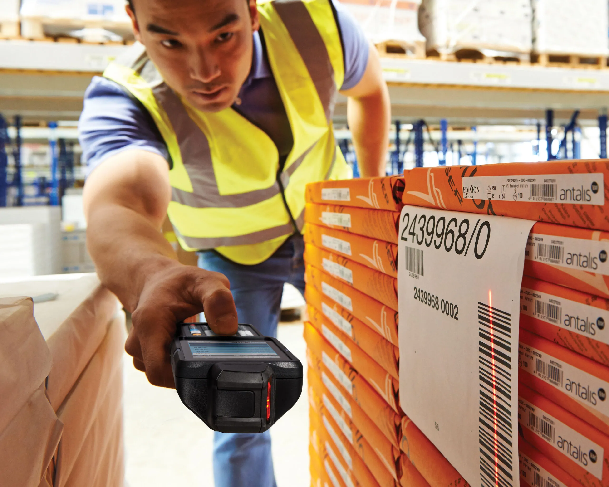 A warehouse operator scanning tagged stock with a handheld RFID reader
